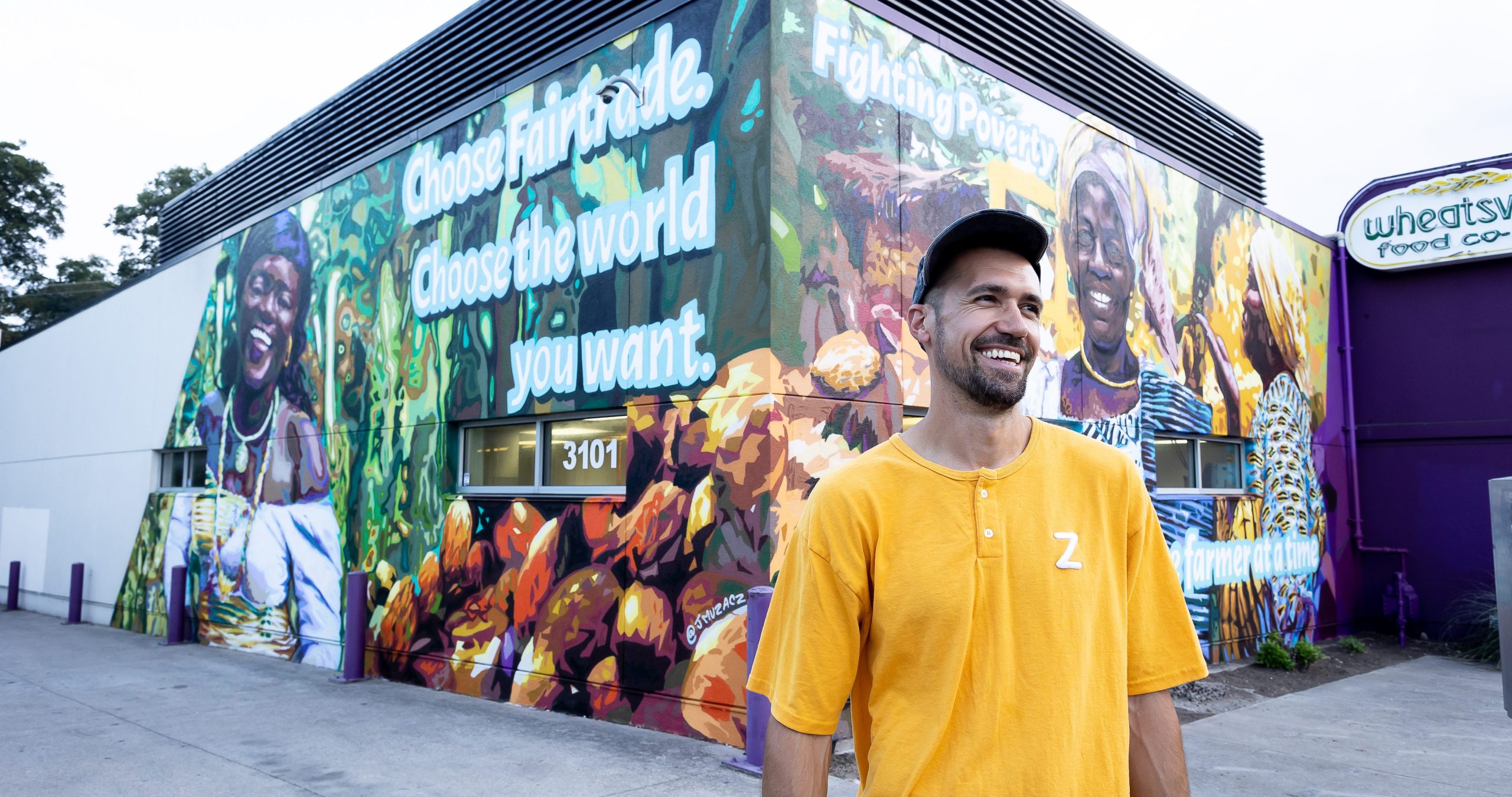 J Muzacz in front of his Fairtrade mural