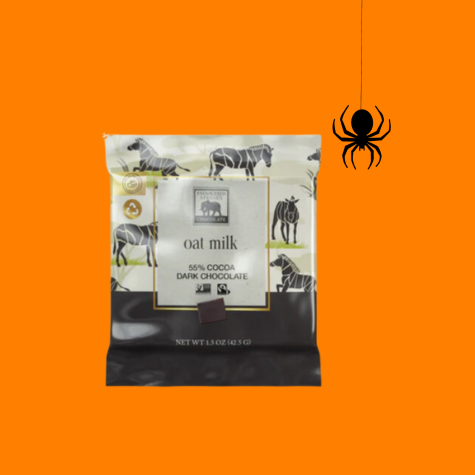 An oat milk dark chocolate “Grab and Go” chocolate square from Endangered Species Chocolate is accompanied by a spider dangling from a thread.