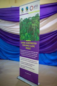 Vertical signage about the Ghana Agroforestry for Impact project, displaying Fairtrade and partner logos.