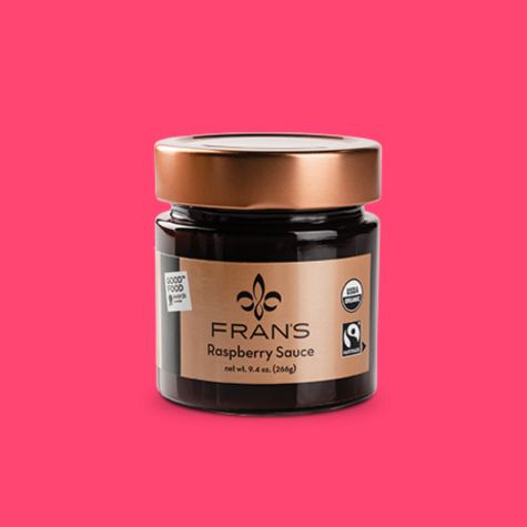 A glass jar of Fairtrade, organic raspberry sauce from Fran's.