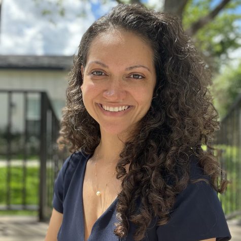 Portrait of Kenzel Fallen, Co-Founder and CEO of Three Keys Coffee. She stands in front of a tree a wrought iron fence.