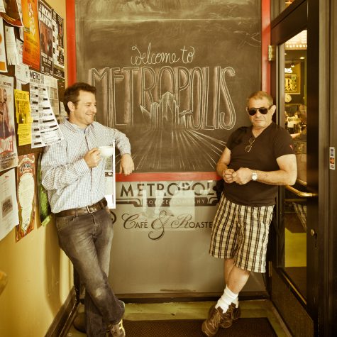 Tony and Jeff Dreyfuss lean against opposite walls in front a chalkboard that reads 